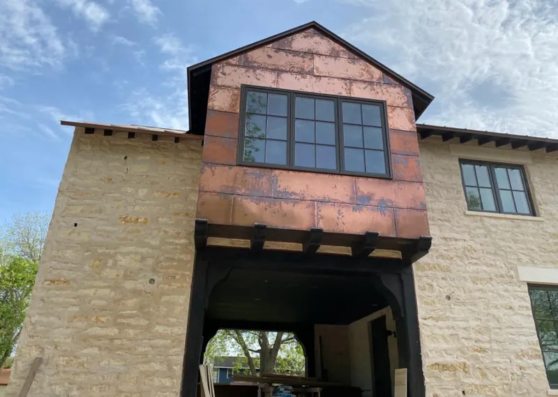 Copper metal panel facade on a stone building for Metal Roof Coating in Edgemere