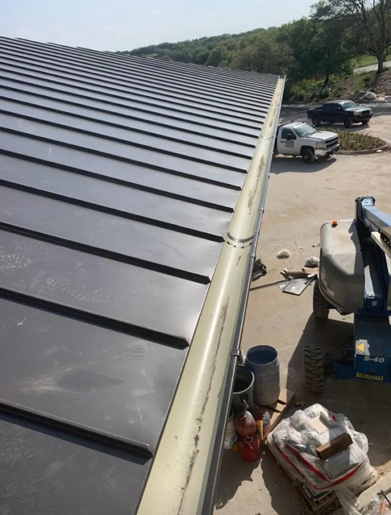 Standing seam panel and gutter detail on a metal roofing jobsite in Edgemere